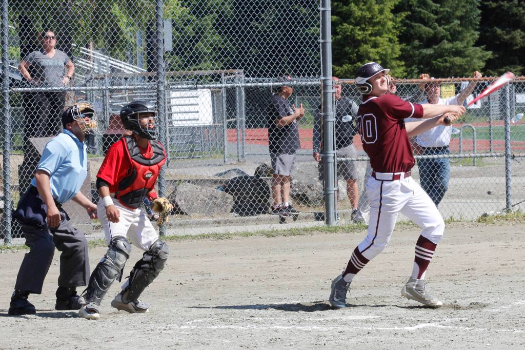 Ketchikans Wyatt Barajas watches a grand slam home run off his bat in the Region V title game on Saturday, May 25, 2019. (Alex McCarthy | Juneau Empire)