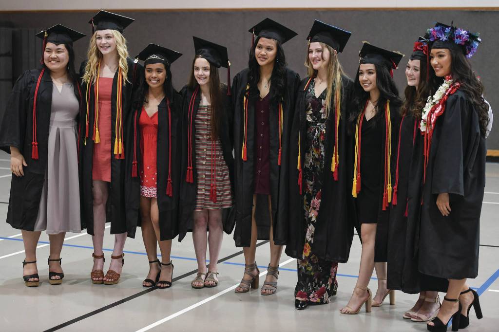 Photos By Michael Penn | Juneau Empire                                Juneau-Douglas High School: Yadaa.at Kalé pose for pictures with each other before the graduation ceremony.