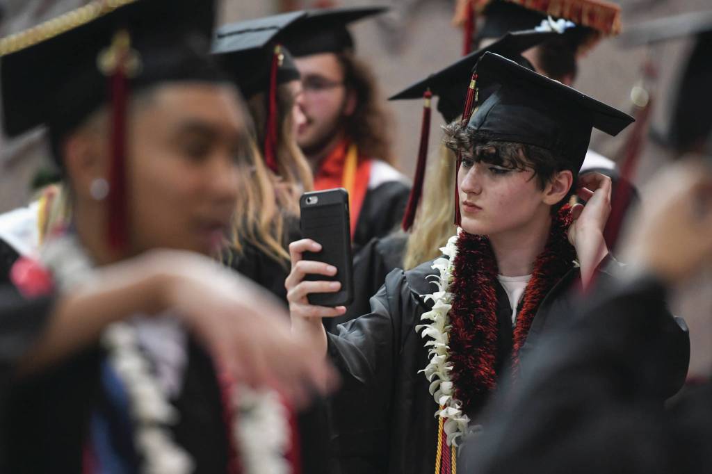 Allena Valentine makes one last check before the Juneau-Douglas High School: Yadaa.at Kalé graduation ceremony.