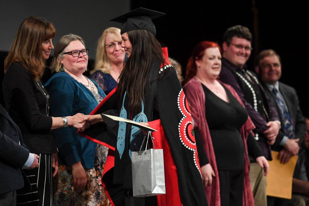 Savannah Strang shakes hands with Juneau School District Superintendent Dr. Bridget Weiss during the Yaakoosgé Daakahidi High School at Centennial Hall on Sunday, May 26, 2019. (Michael Penn | Juneau Empire)