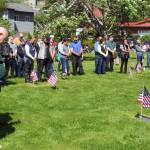 Attendees bow their heads during prayer at a Memorial Day Ceremony held at Evergreen Cemetery, Monday, May 27. (Ben Hohenstatt | Juneau Empire)