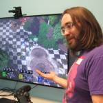 Casey Harris, co-owner of Game On, explains how to play a game during the first Trans Gaming Night at Game On, Saturday, Feb. 23, 2019. (Ben Hohenstatt | Capital City Weekly)