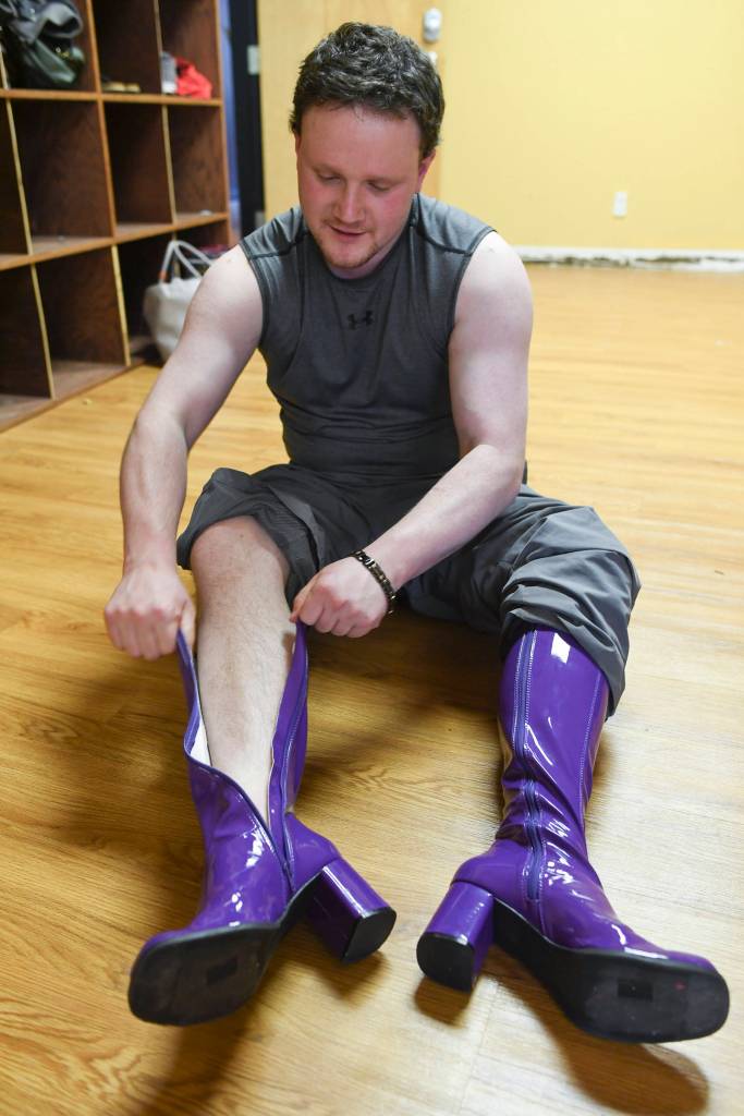 Mitchell Leggett puts on his heeled boots during practice for the the 5th annual GLITZ Drag Show to be held at Centennial Hall on Friday and Saturday, June 15 and 16. (Michael Penn | Juneau Empire)