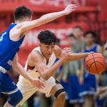 Juneau-Douglas Israel Yadao drives against Thunder Mountains Hansel Hinckle at JDHS on Friday, Jan. 25, 2019. Thunder Mountain won 67-63. (Michael Penn | Juneau Empire File)