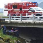 Rescuers help person under bridge