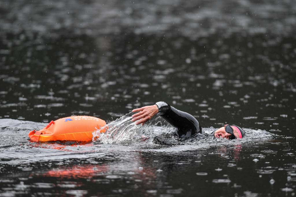 Triathlon coach Jamie Bursell swims in Auke Lake on Wednesday, June 5, 2019. (Michael Penn | Juneau Empire)
