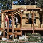 Juneau Raptor Center board members Janet Capito, left, and Dale Cotton, second from right, talk with Matthew Kenkle and Joseph Staran, right, of Silverbow Construction, about construction on a new education display on Mount Roberts on Thursday, March 28, 2019. The display will house Lady Baltimore, an adult bald eagle that is not releasable back to the wild. (Michael Penn | Juneau Empire File)