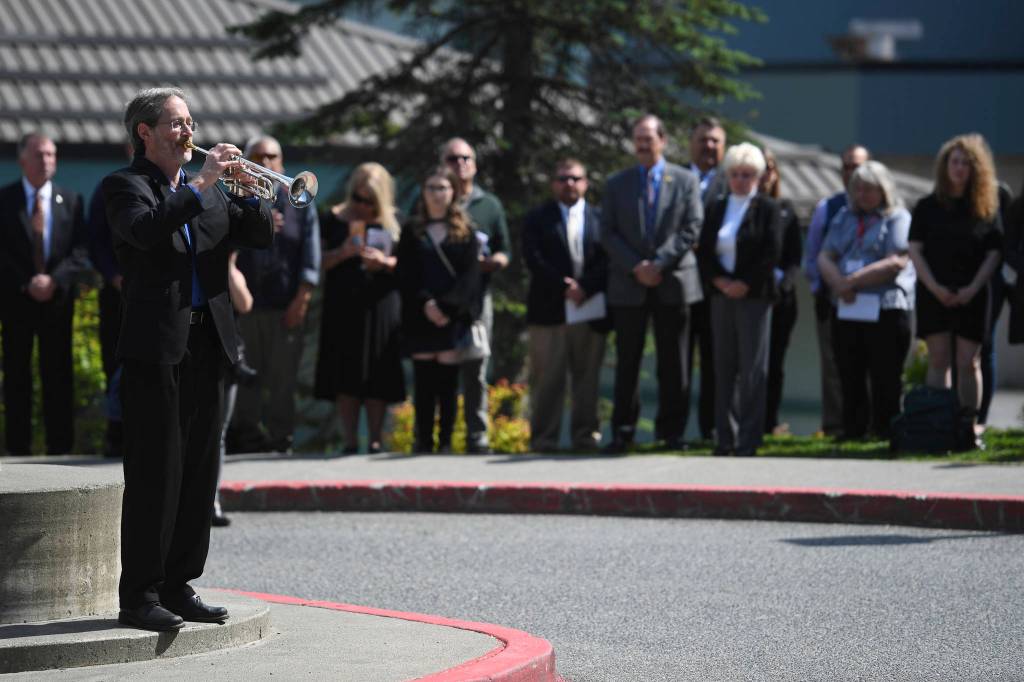 Rick Trostel plays taps at the end of the memorial service for the Guardian Flight crew held at Juneau-Douglas High School: Yadaa.at Kalé on Friday, June 7, 2019. (Michael Penn | Juneau Empire)