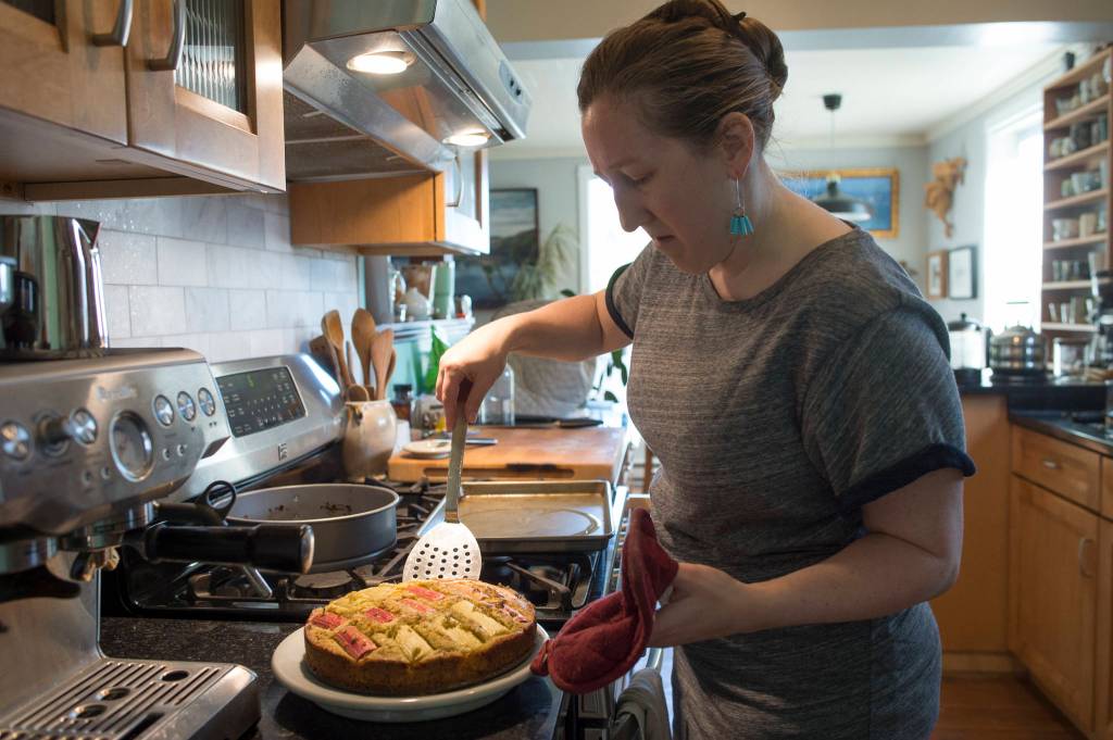 Erin Anais Heist prepares spruce tip rhubarb cake in her home kitchen on Thursday, June 6, 2019. (Michael Penn | Juneau Empire)