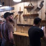 Ryan OShaughnessy studies the collection of antique woodworking tools collected by Dick Wood during First Friday at Devils Club Brewing Company on Friday, June 7, 2019. (Michael Penn | Juneau Empire)