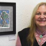 Robin Hiersche stands next to her watercolor painting The Fish Tree in the Juneau Arts and Humanities Councils Juried Art Show for First Friday on Friday, June 7, 2019. (Michael Penn | Juneau Empire)