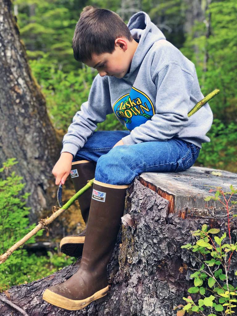 Jackson Pearson works on devils club. (Vivian Faith Prescott | Capital City Weekly)