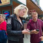 Jennifer Miller, 18, and Gavin Blood, 22, catch Pokémon while playing Pokémon Go in this June 2016 file photo. 5G mobile network service which GCI announced Tuesday is coming to Alaska, will result in faster device speeds. (Michael Penn | Juneau Empire File)