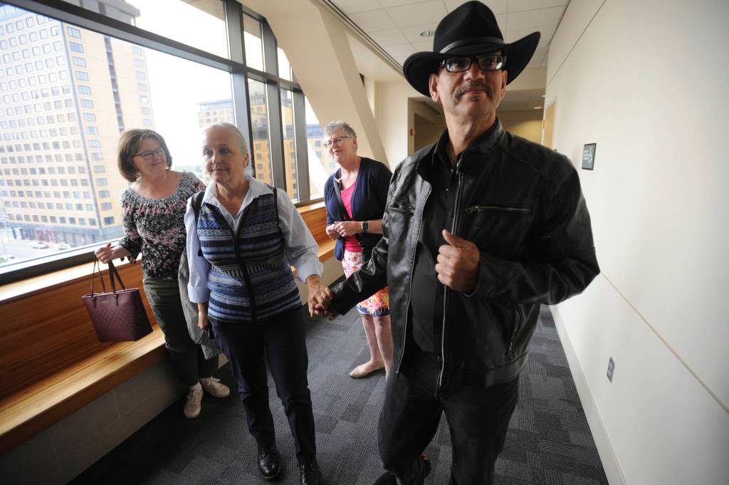 Timothy Hoffman, right, father of slain teenager Cynthia Hoffman receives support from Edie Grunwald, left, whos son David Grunwald was murdered in Nov. 2016, as they entered a Superior courtroom for the arraignment of Cynthias murder suspects in the Nesbett Courthouse on Tuesday, June 18, 2019 in Anchorage. (Bill Roth/Anchorage Daily News via AP)