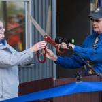 Port Director Carl Uchytil hands oversized scissors toTravel Juneau President & CEO Liz Perry during a ceremony to open the new Visitors Center Kiosk, Friday, May 17, 2019. Uchytil is talking to the Greater Juneau Chamber of Commerce today. (Michael Penn | Juneau Empire)