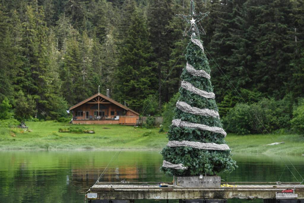 A Christmas tree decorates an anchored platform at Amalga Harbor on Wednesday, June 19, 2019. (Michael Penn | Juneau Empire)