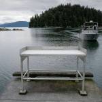 A fisherman approaches the boat launch with its current fish cleaning station at Amalga Harbor on Wednesday, June 19, 2019. (Michael Penn | Juneau Empire)