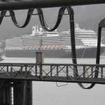 The Holland America Line Eurodam pulls into Juneaus downtown harbor heading for the city-owned dock on Monday, May 6, 2019. The privately owned South Franklin Dock, foreground, is currently the only dock set up to provide electric power to a ship while at berth in Juneau. (Michael Penn | Juneau Empire File)