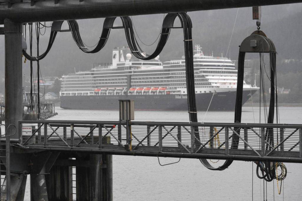 The Holland America Line Eurodam pulls into Juneaus downtown harbor heading for the city-owned dock on Monday, May 6, 2019. The privately owned South Franklin Dock, foreground, is currently the only dock set up to provide electric power to a ship while at berth in Juneau. (Michael Penn | Juneau Empire File)