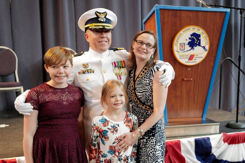U.S. Coast Guard Commander Andrew S. Joca poses with his wife, Katie, and daughters, Molly, 11, and Amelia, 8, after a Change of Command ceremony at the Juneau Arts and Culture Center on Thursday, June 20, 2019. (Michael Penn | Juneau Empire)