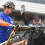 Bill Wilcox, right, watches contestant Brad Staley in the jackleg drilling contest during the Mining & Logging Competition at the 29th Annual Gold Rush Days at Savikko Park on Saturday, June 22, 2019. (Michael Penn | Juneau Empire)