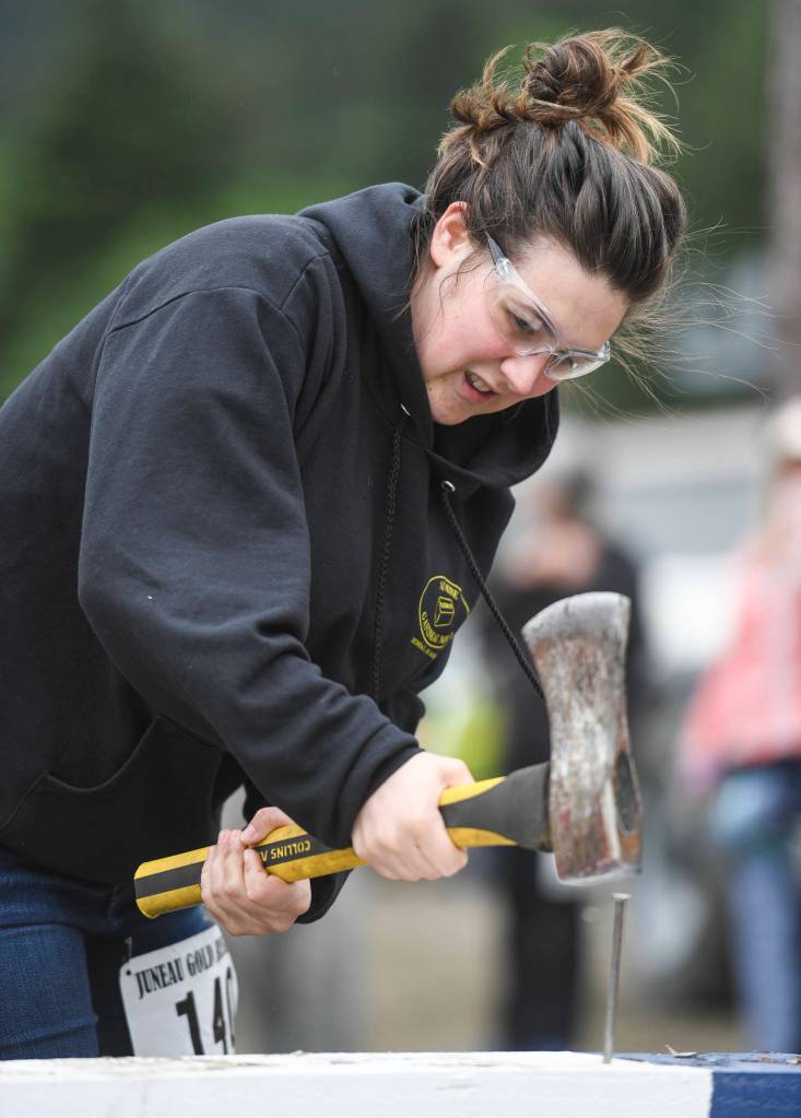 Abigail Hoy competes in the spike driving contest during the Mining & Logging Competition at the 29th Annual Gold Rush Days at Savikko Park on Saturday, June 22, 2019. (Michael Penn | Juneau Empire)