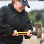 Andrea Petrie competes in the spike driving contest during the Mining & Logging Competition at the 29th Annual Gold Rush Days at Savikko Park on Saturday, June 22, 2019. (Michael Penn | Juneau Empire)