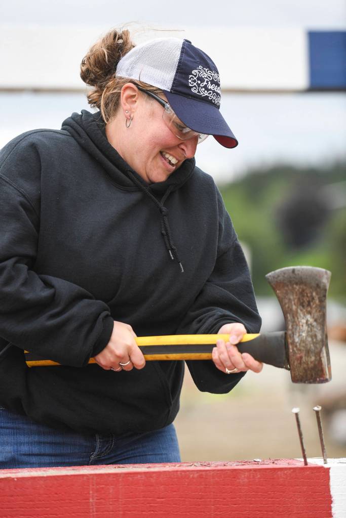 Andrea Petrie competes in the spike driving contest during the Mining & Logging Competition at the 29th Annual Gold Rush Days at Savikko Park on Saturday, June 22, 2019. (Michael Penn | Juneau Empire)