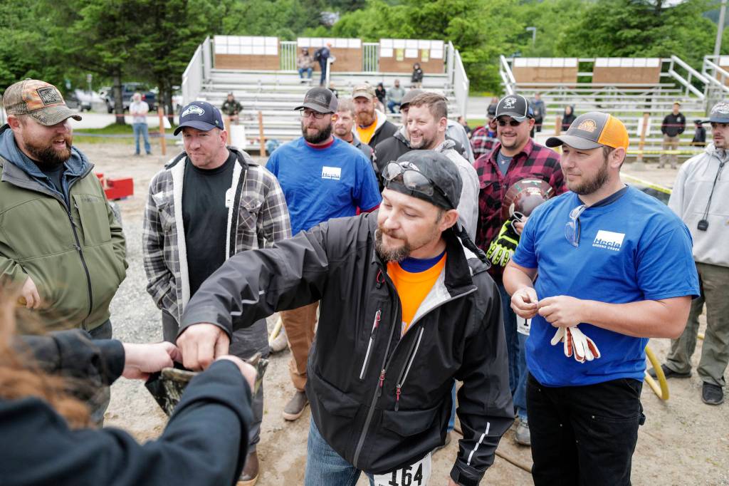 Heath Coro steps up to pick a number before the jackleg drill contest during the Mining & Logging Competition at the 29th Annual Gold Rush Days at Savikko Park on Saturday, June 22, 2019. (Michael Penn | Juneau Empire)