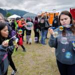 Chloe Vonta, 15, left, and Brianna Elisoff, 14, entertain themselves making soap bubbles at the 29th Annual Gold Rush Days at Savikko Park on Saturday, June 22, 2019. (Michael Penn | Juneau Empire)