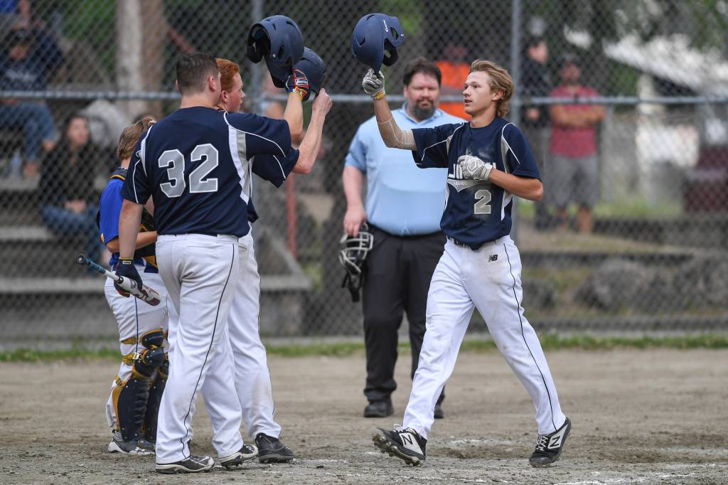 Juneaus Gabe Storie, right, touches helmets with teammate Robert Cox and Luke Mallinger after hitting a two run homer in the fourth inning against Bartlett in Legion League baseball at Adair-Kennedy Memorial Park on Friday, June 21, 2019. (Michael Penn | Juneau Empire)