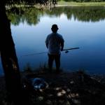 Kyle Wales waits and watches for a king salmon to rise in the Fish Creek Pond on Tuesday, June 25, 2019. (Michael Penn | Juneau Empire File)