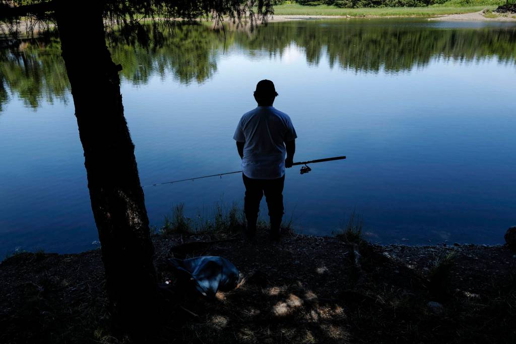 Kyle Wales waits and watches for a king salmon to rise in the Fish Creek Pond on Tuesday, June 25, 2019. (Michael Penn | Juneau Empire File)