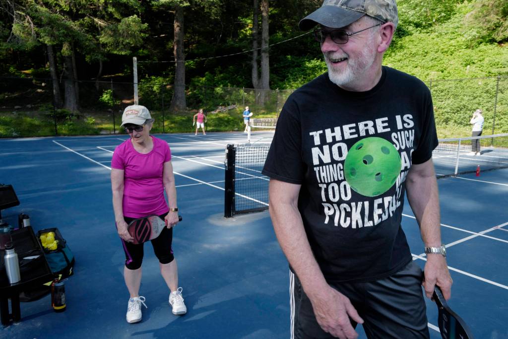 Ted Carte heads out for another game of pickleball at the Cope Park tennis courts on Wednesday, June 26, 2019. (Michael Penn | Juneau Empire)