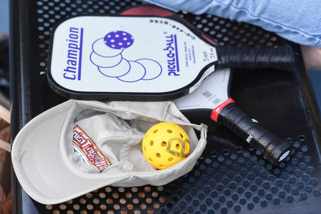 Pickleball paddles and ball at the Cope Park tennis courts on Wednesday, June 26, 2019. (Michael Penn | Juneau Empire)