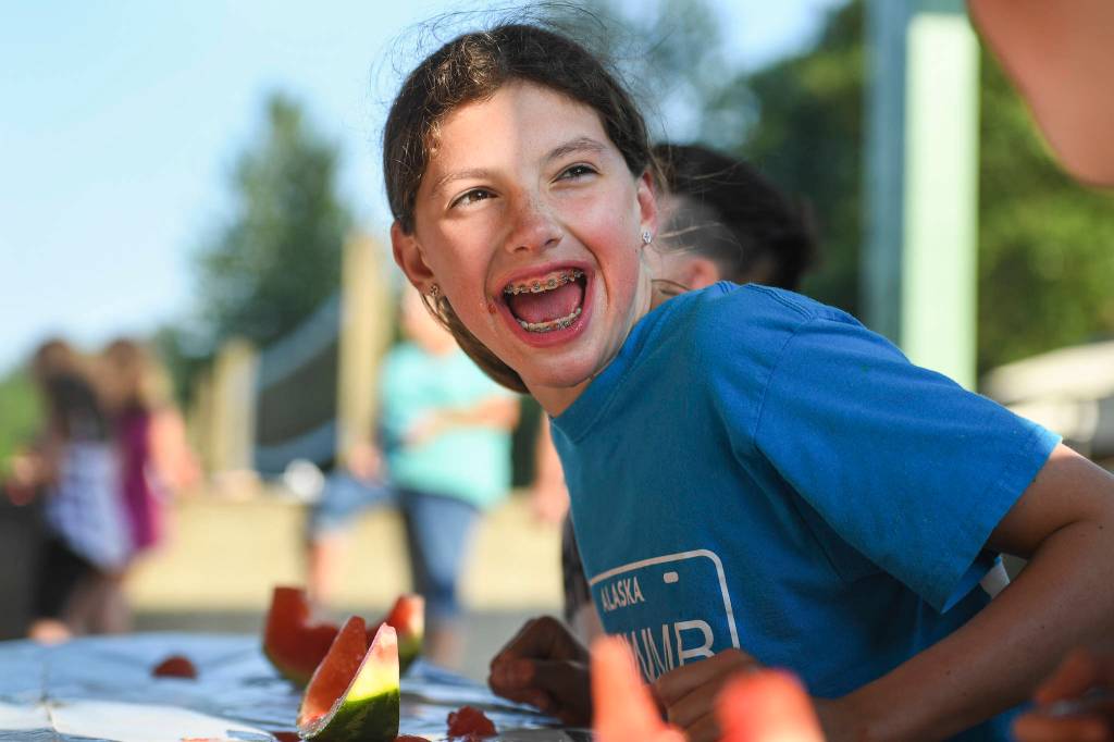 Emma Fellman, 12, celebrates her watermelon eating contest win for her age group during a community picnic sponsored by the Douglas Fourth of July Committee and Capital City Fire/Rescue at Sandy Beach on Wednesday, July 3, 2019. (Michael Penn | Juneau Empire)