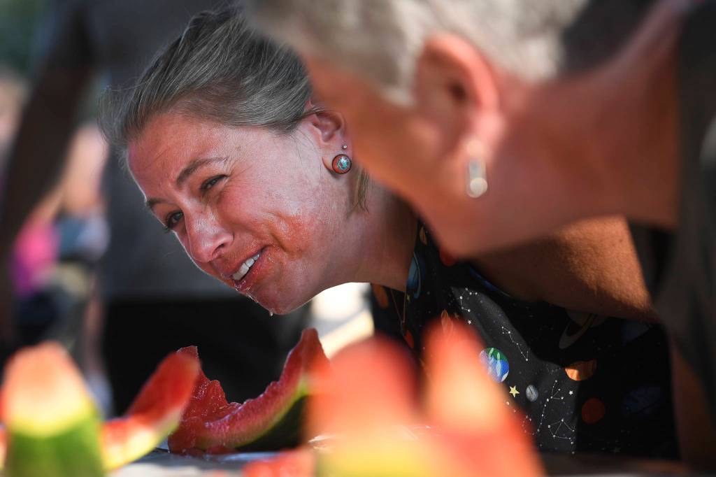 Sara Chapell reacts during the adult watermelon eating contest during a community picnic sponsored by the Douglas Fourth of July Committee and Capital City Fire/Rescue at Sandy Beach on Wednesday, July 3, 2019. (Michael Penn | Juneau Empire)