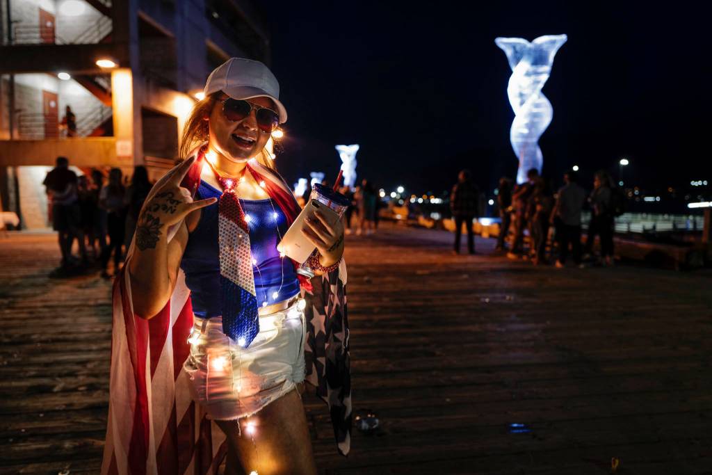 Savannah Meketa shows her patriotic spirit as Juneau residents gather around the downtown waterfront to watch the annual fireworks display on Wednesday, July 3, 2019. (Michael Penn | Juneau Empire)