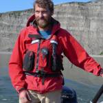 Pat Druckenmiller, dinosaur guy of the University of Alaska Museum, ferries a boat across the Colville River near the spot rich with dinosaur bones. (Courtesy photo | Greg Erickson)