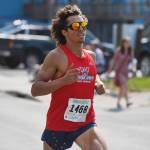 Riley Moser finishes first in the Glenn Frick Memorial Mile on Thursday, July 4, 2019. (Michael Penn | Juneau Empire)