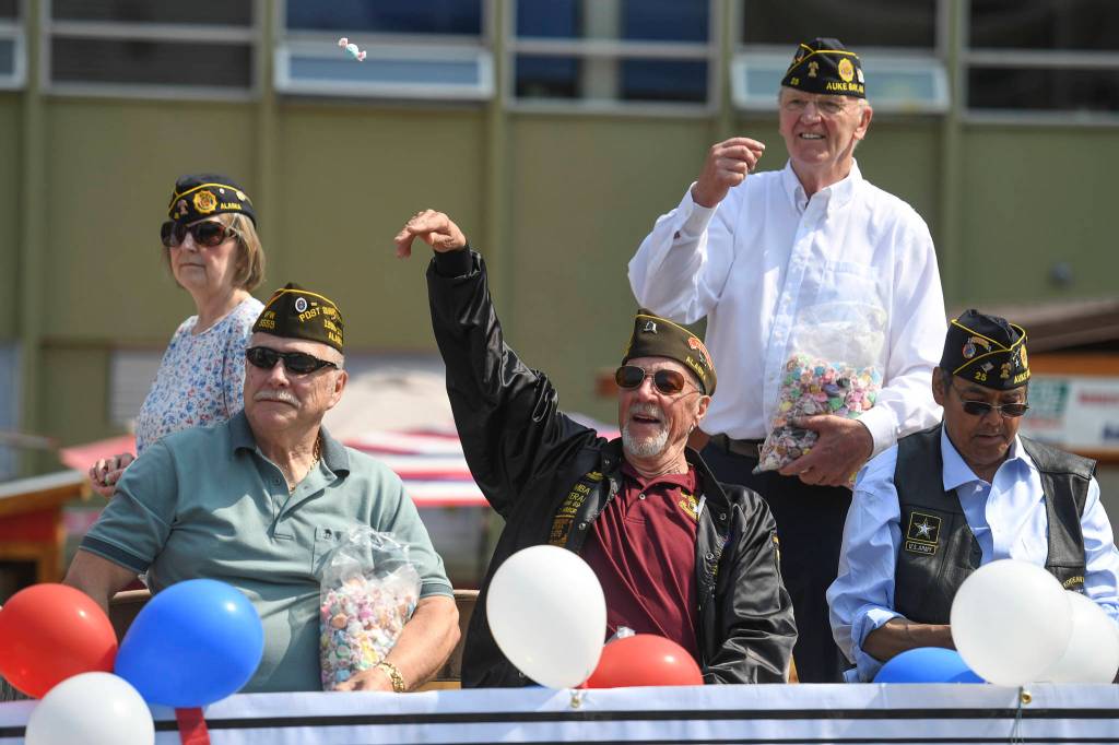 Members of the Veterans of Foreign Wars throw candy from their float during the Juneau Fourth of July Parade on Thursday, July 4, 2019. (Michael Penn | Juneau Empire)