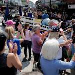 People applaud as a Alaska Marine Highway System float goes by during the Juneau Fourth of July Parade on Thursday, July 4, 2019. (Michael Penn | Juneau Empire)