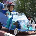 Ona Eckerson, 5, begins the Soapbox Challenge during the Douglas Fourth of July festivities on Thursday, July 4, 2019. Eckerson and her older brothers Aaro, 7, and Inde, 10, shared the same car which they decorated with plastic products to raise awareness of plastic pollution in the ocean. (Nolin Ainsworth | Juneau Empire)