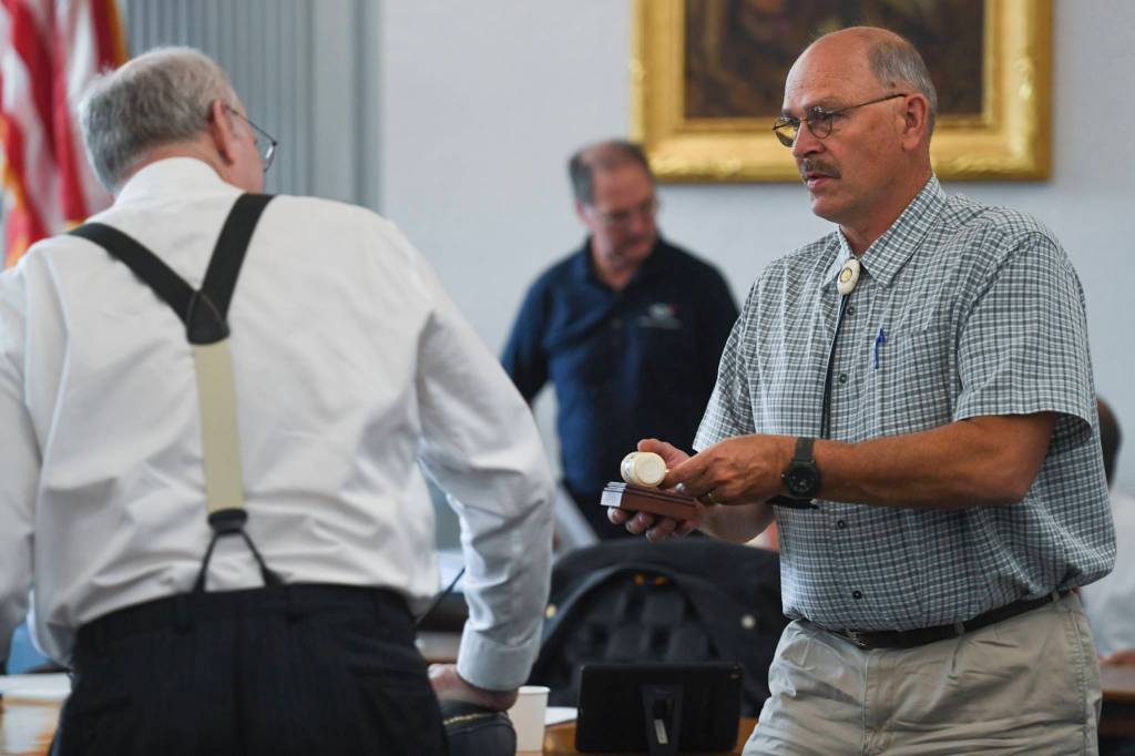 Bicameral Permanent Fund Working Group Co-Chair Click Bishop, R-Fairbanks, right, hands a gavel back to Senate Finance Co-Chair Sen. Bert Stedman, R-Sitka, after a meeting of the group to hear presentations at the Capitol on Monday, July 8, 2019. (Michael Penn | Juneau Empire)