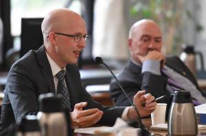 Rep. Jonathan Kreiss-Tomkins, D-Sitka, present one of three papers as Rep. Adam Wool, D-Fairbanks, listens during a Bicameral Permanent Fund Working Group at the Capitol on Monday, July 8, 2019. (Michael Penn | Juneau Empire)