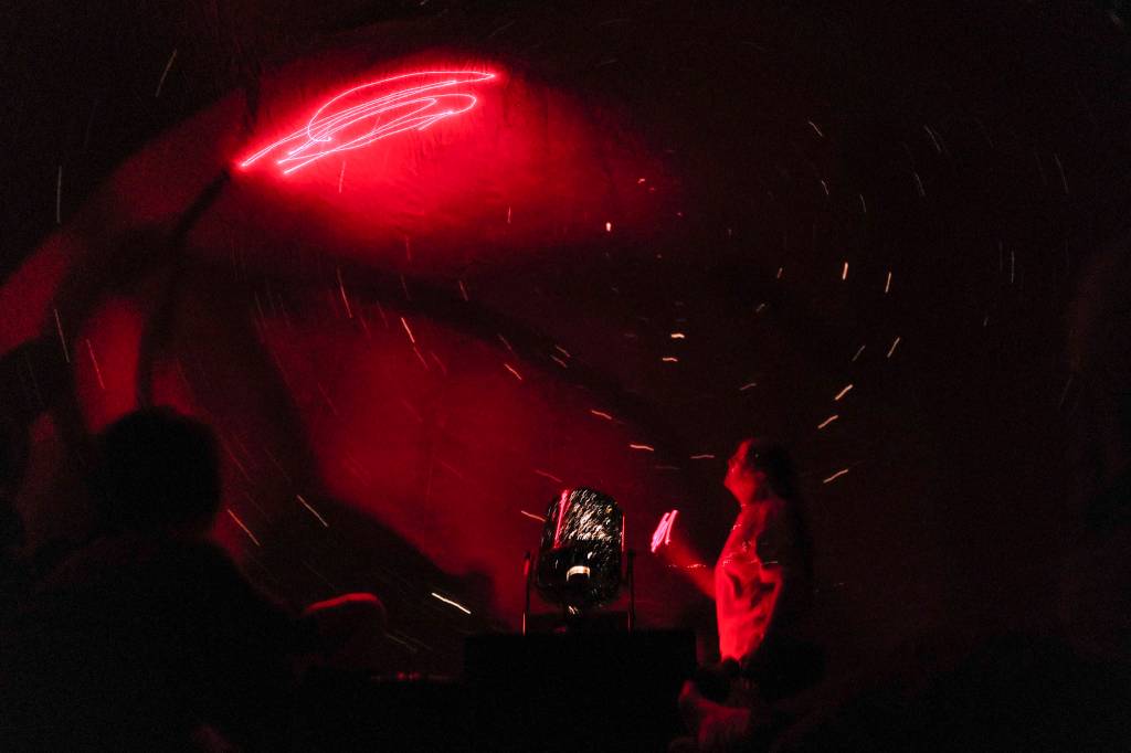 Rosemary Walling, a board member of the Marie Drake Planetarium, gives a presentation on the night sky inside a portable planetarium at the Alaska State Museum on Friday, July 5, 2019. (Michael Penn | Juneau Empire)