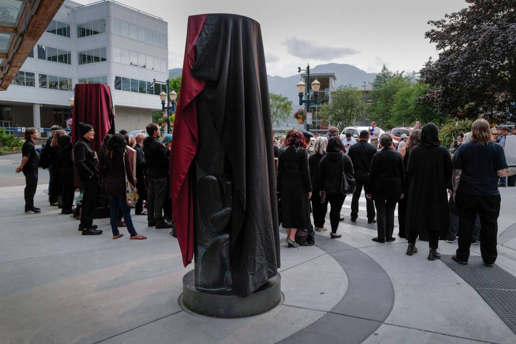 About 50 artists stand with their work in front of the Sealaska Heritage Institute on Tuesday, July 9, 2019, to protest heavy cuts to state arts programs. (Michael Penn | Juneau Empire)