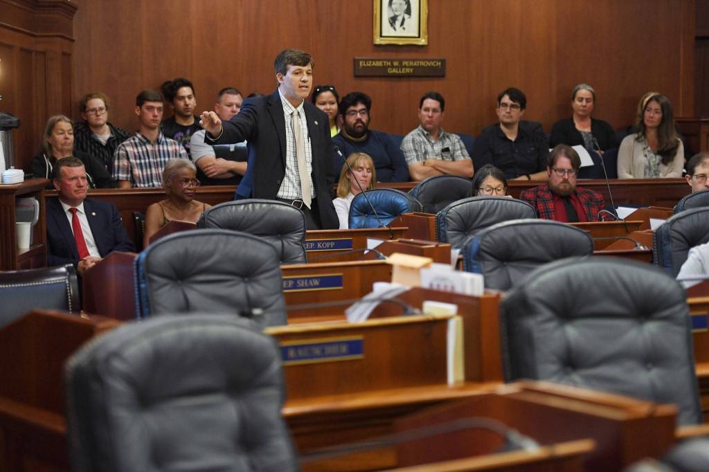 With empty legislator seats in front of him, Sen. Bill Wielechowski, D-Anchorage, speaks in favor of an override vote during a Joint Session of the Alaska Legislature to vote on an override of Gov. Mike Dunleavys budget vetoes at the Capitol on Wednesday, July 10, 2019. (Michael Penn | Juneau Empire)