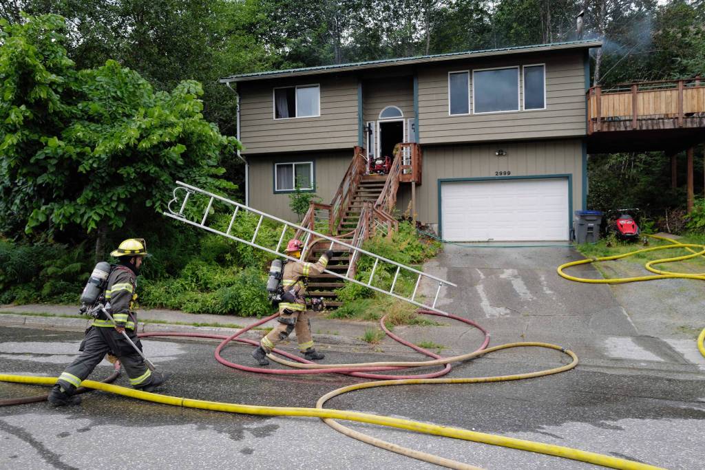 Capital City Fire/Rescue responds to a house fire at 2999 Foster Avenue on Thursday, July 11, 2019. (Michael Penn| Juneau Empire)