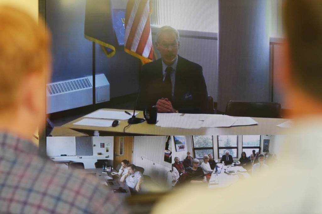 University of Alaska Southeast administrators and staff watch University President Jim Johnsen during an online meeting being held at UA campuses around the state on Gov. Mike Dunleavys budget cuts on Monday, July 15, 2019. (Michael Penn | Juneau Empire)